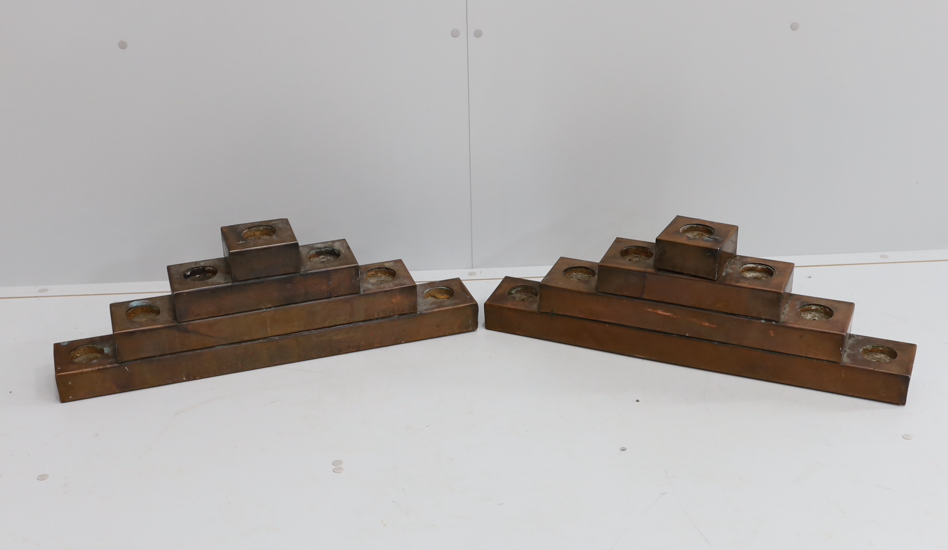 A pair of copper mounted candle holders, width 72cm, height 23cm